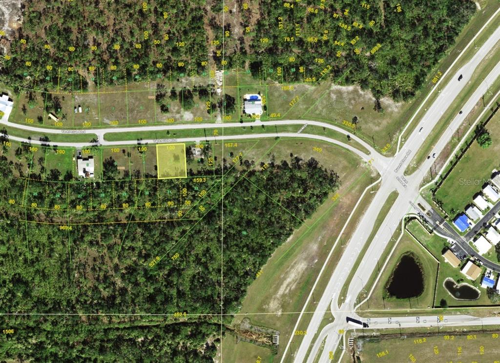 An aerial map shows a highlighted rectangular residential lot situated along a curved road — 24581 YACHT CLUB BOULEVARD, PUNTA GORDA, FL