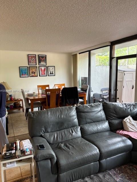 A living room with a gray leather sofa faces a dining area with framed artwork — 3190 Bird Ave # 15, Coconut Grove FL 33133, COCONUT GROVE, FL