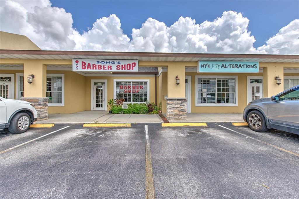 A strip mall storefront featuring a barber shop and an alterations business with parking spaces — 2156 CO RD 540A, LAKELAND, FL