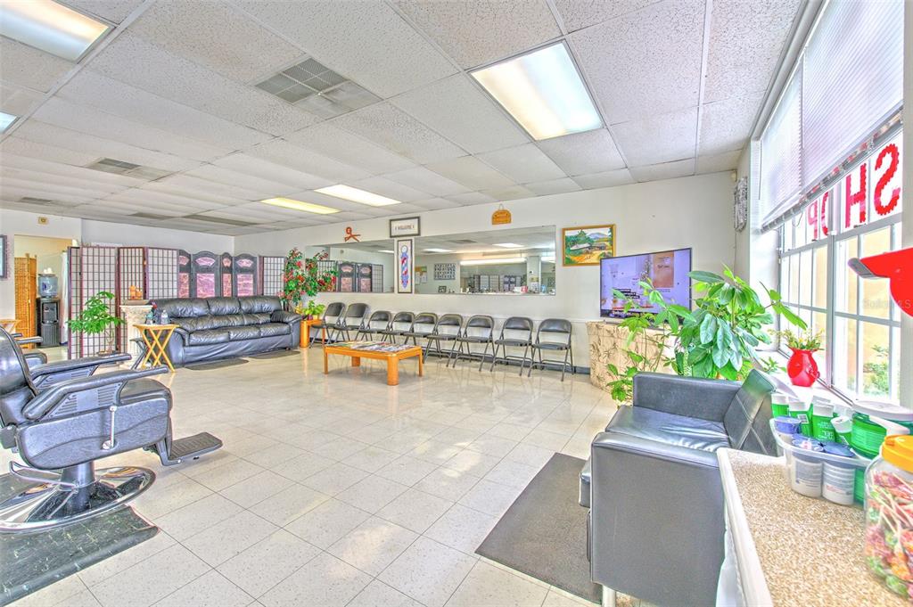 A commercial waiting area features tiled floors, a leather sofa, and a row of chairs — 2156 CO RD 540A, LAKELAND, FL