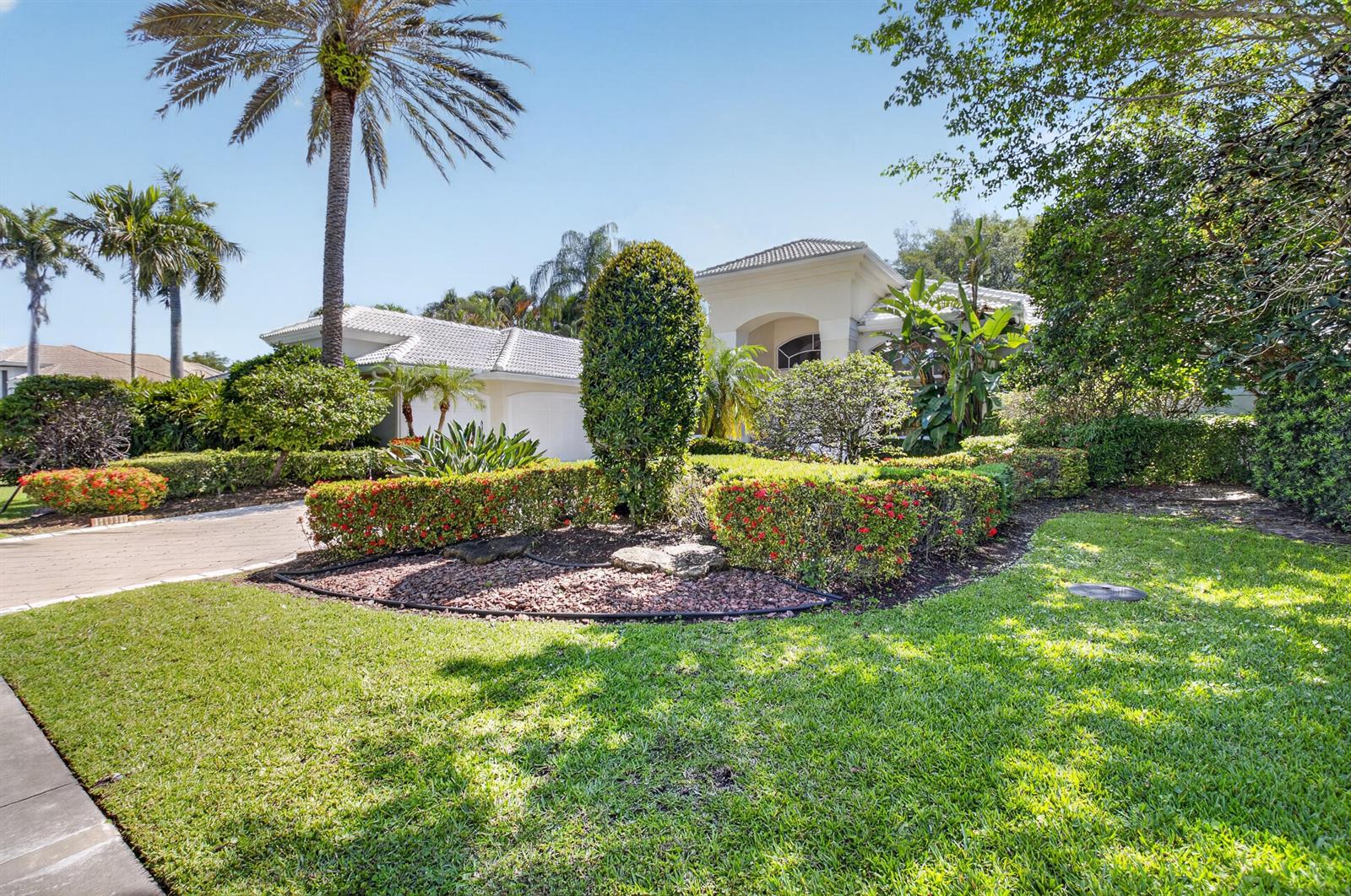 A single-story house with a tiled roof, palm trees, and manicured landscaping in the front yard — 21650 Frontenac Court, Boca Raton FL 33433, BOCA RATON, FL