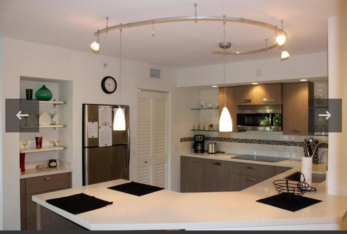 A kitchen features a curved track lighting system, stainless steel appliances, and a white countertop — 808 Villa Circle, Boynton Beach FL 33435, BOYNTON BEACH, FL