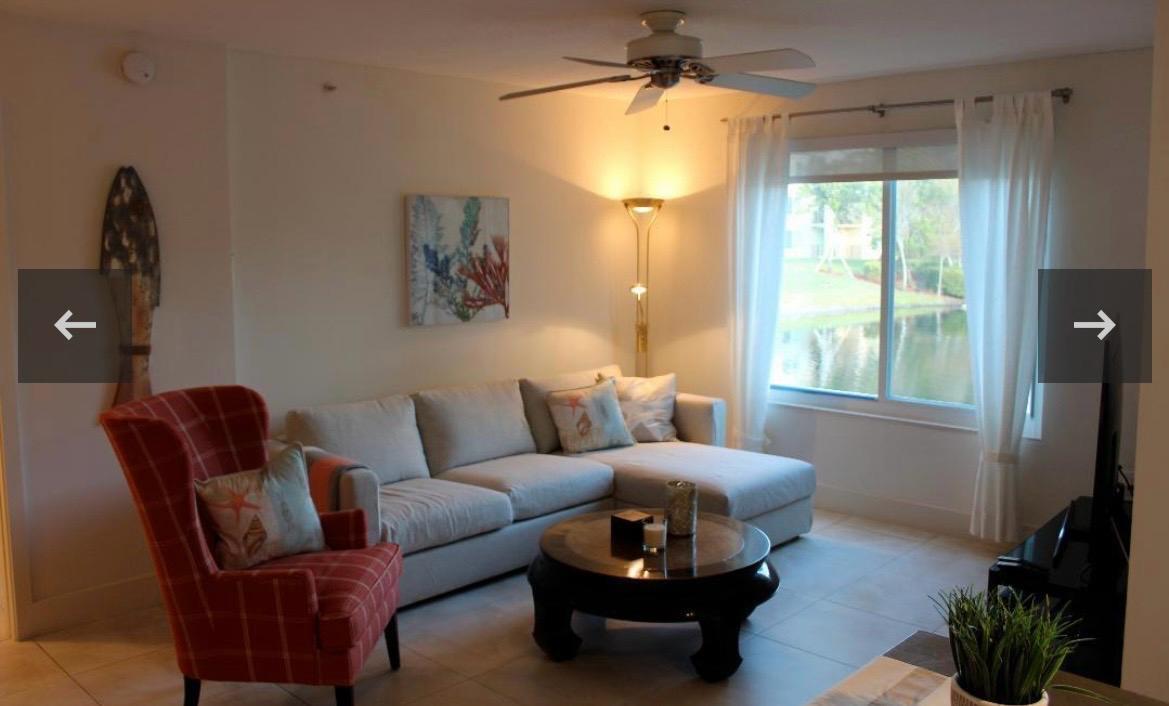 A living room features a sectional sofa, a red plaid armchair, and a large window — 808 Villa Circle, Boynton Beach FL 33435, BOYNTON BEACH, FL