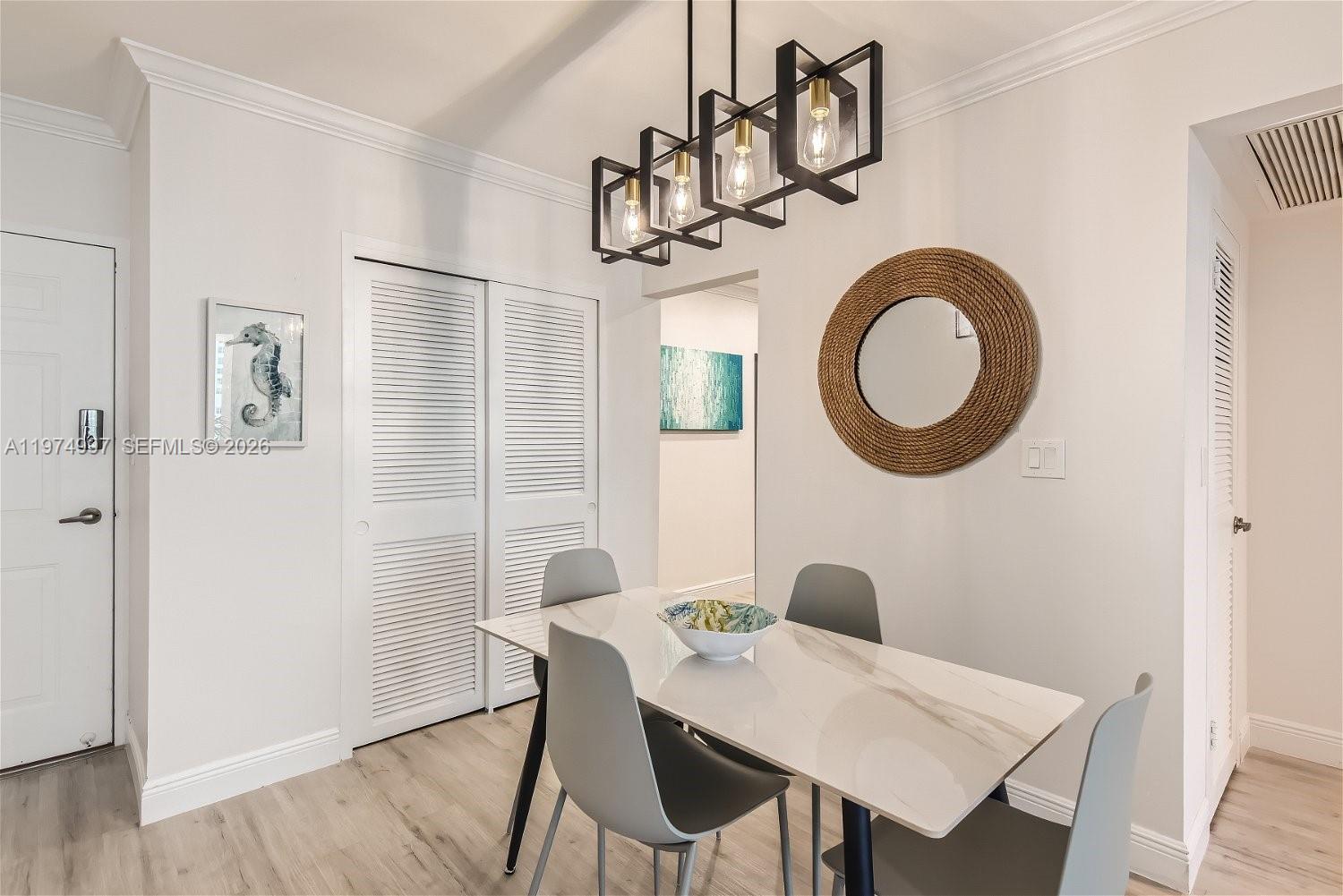 A dining area features a white marble table, grey chairs, and a rectangular pendant light — 2501 S Ocean Dr, Hollywood FL 33019, HOLLYWOOD, FL