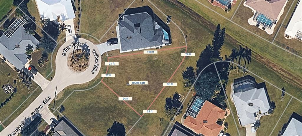 This aerial map shows a vacant residential lot outlined in red within a suburban neighborhood — 204 YELLOW ELDER, PUNTA GORDA, FL