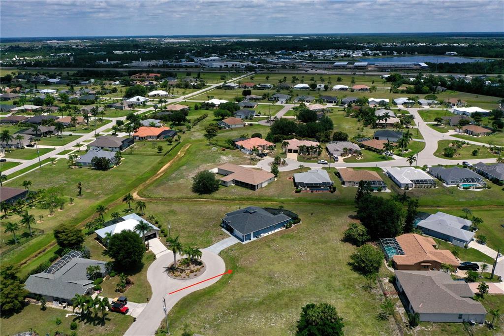 An aerial view shows a suburban neighborhood with single-family homes and a cul-de-sac — 204 YELLOW ELDER, PUNTA GORDA, FL