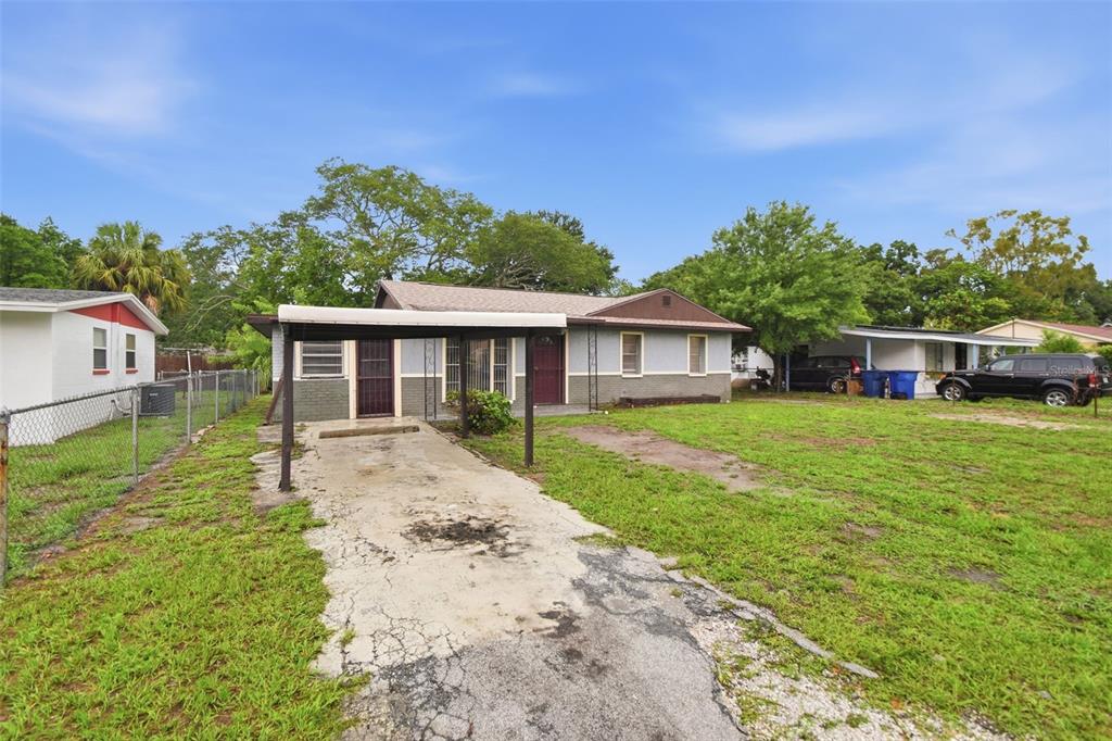 A single-story house with a carport, a concrete driveway, and a large front yard — 3008 N 43RD STREET, TAMPA, FL