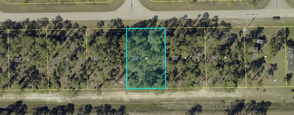 This aerial map shows a rectangular, wooded residential lot highlighted in blue along a road — 522 KELLER STREET E, LEHIGH ACRES, FL