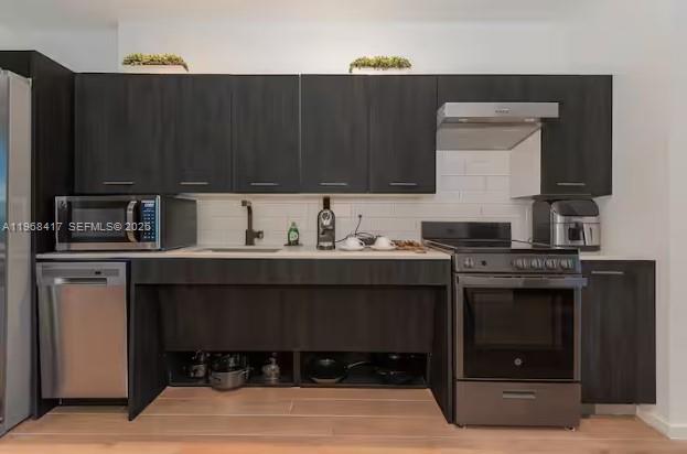 A kitchen features dark wood cabinetry, stainless steel appliances, and an open-concept lower storage area — 398 NE 5th St # 3511, Miami FL 33132, MIAMI, FL