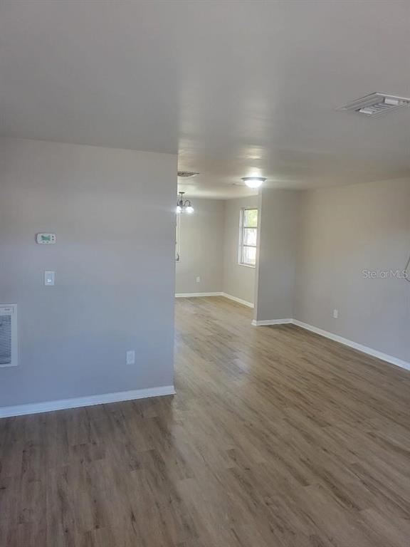 An interior view of a living area with light-colored walls and wood-look flooring — 3775 SW 147TH LANE ROAD, OCALA, FL