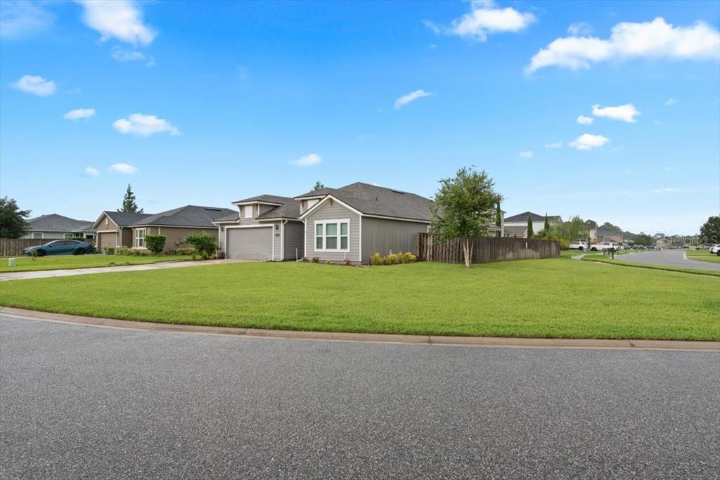 A single-story suburban house with a gray exterior, a two-car garage, and a large lawn — 27 COLORADO SPRINGS WAY, ST AUGUSTINE, FL