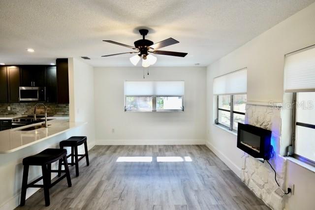 A kitchen with dark cabinets and a breakfast bar opens into a dining area — 9120 SW 210TH CIRCLE, DUNNELLON, FL