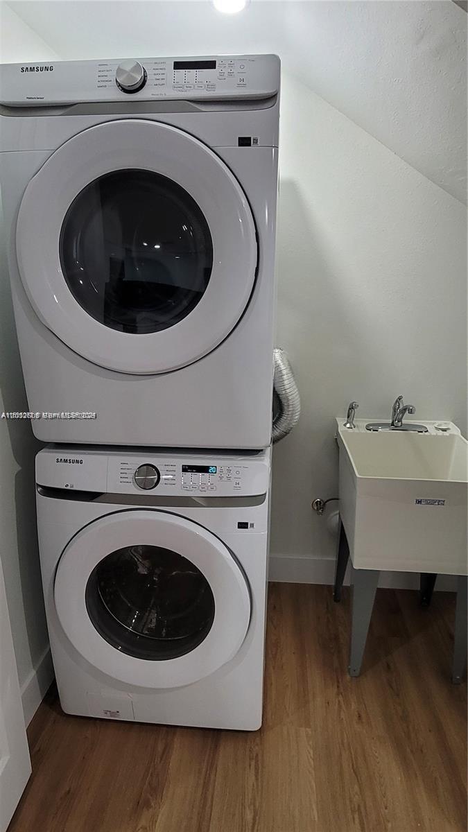 A laundry room features a stacked Samsung washer and dryer next to a utility sink — 16955 SW 100th Ave # 1, Miami FL 33157, MIAMI, FL
