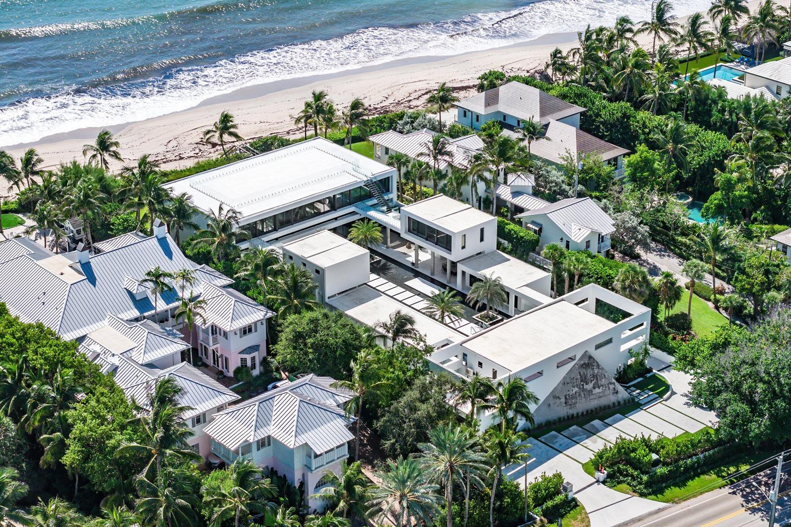 An aerial view of a modern beachfront estate with multiple buildings, pools, and lush landscaping — 6273 N Ocean Boulevard, Ocean Ridge FL 33435, OCEAN RIDGE, FL