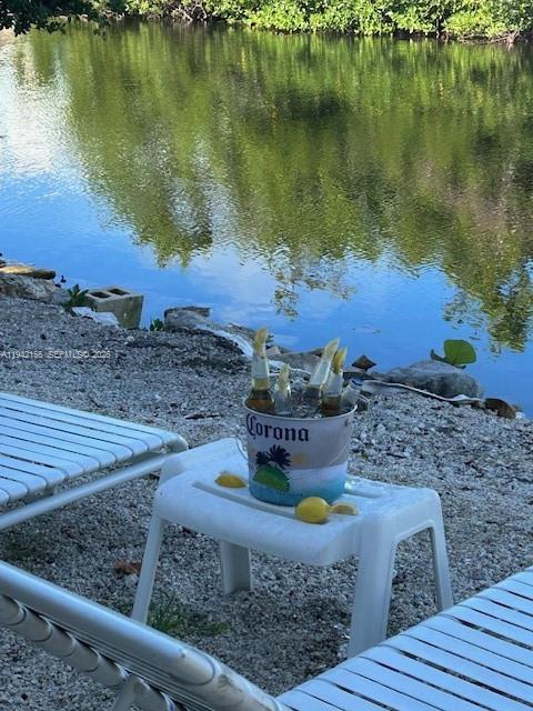 A bucket of Corona beer sits on a small white table by a waterfront — 74 Pelican Ln, Big Pine FL 33043, BIG PINE, FL
