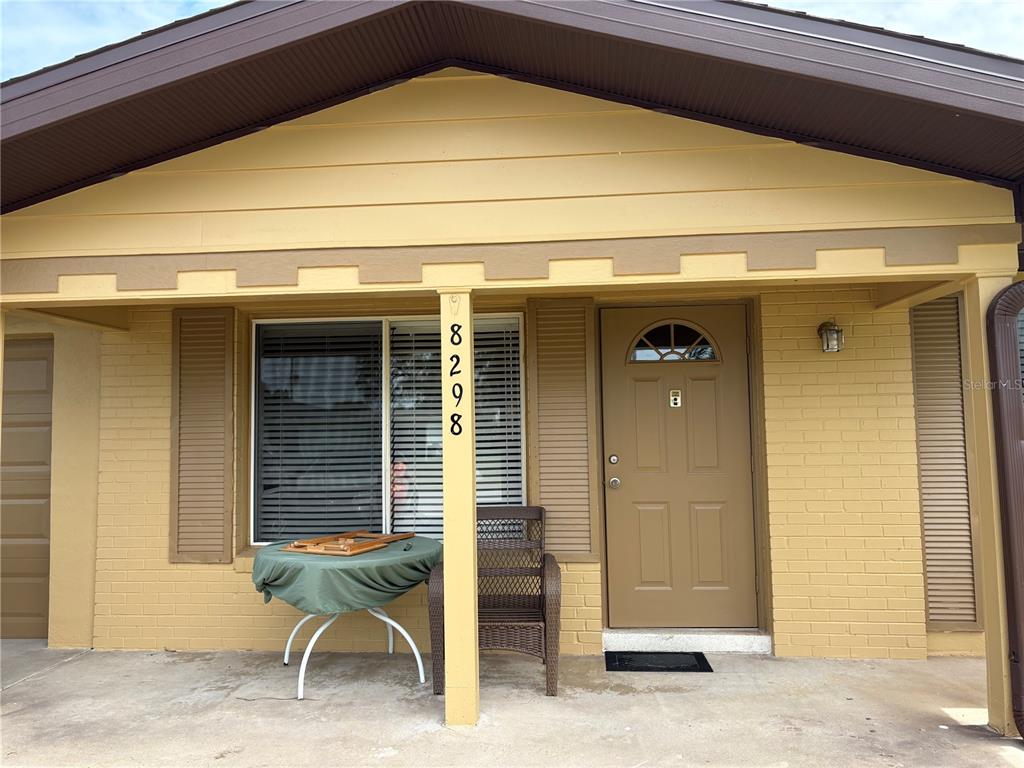 A kitchen features white cabinets, stainless steel appliances, and light-colored countertops — 8298 FAY AVENUE, NORTH PORT, FL