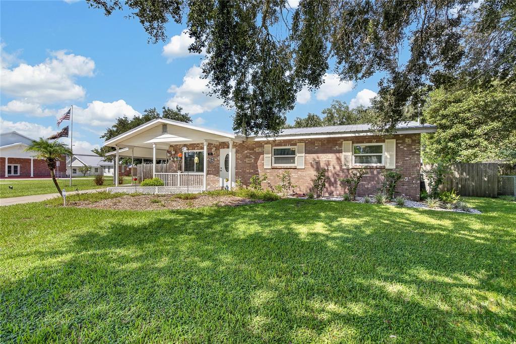 A single-story brick house features a covered front porch and a large, grassy front yard — 2801 BLAIN ACRES ROAD, PLANT CITY, FL