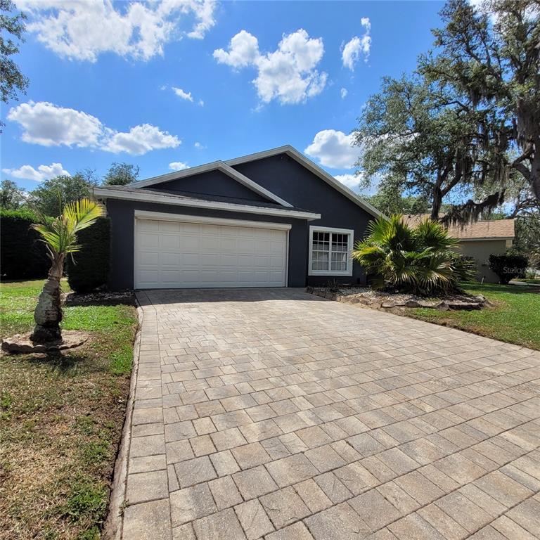 A dark gray house with a white garage door and a paved driveway — 991 OLD CUTLER ROAD, LAKE WALES, FL