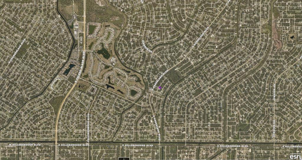 This is an aerial map view of a residential neighborhood with winding streets and lakes — 1141177118 DERRICK STREET, NORTH PORT, FL