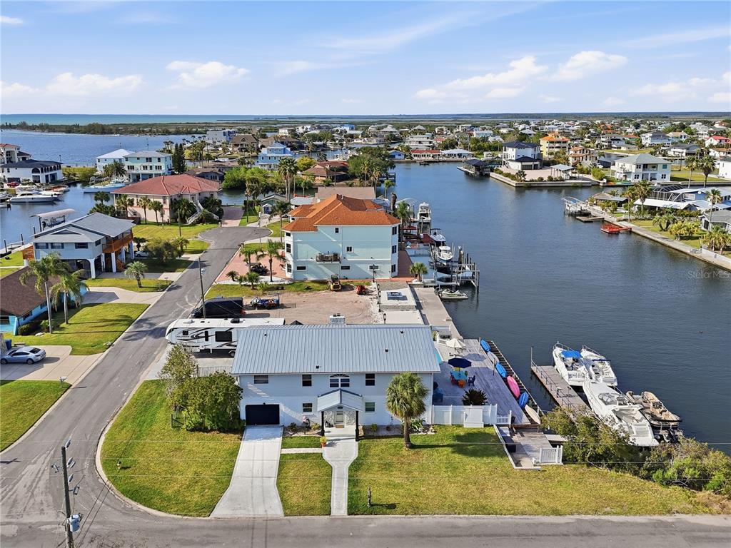 An aerial view shows a waterfront house with a boat dock and parked RV — 3173 GULFVIEW DRIVE, HERNANDO BEACH, FL