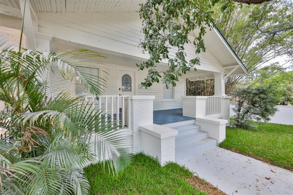 A white bungalow with a front porch, concrete walkway, and a large tree in front — 902 W COLUMBUS DRIVE, TAMPA, FL
