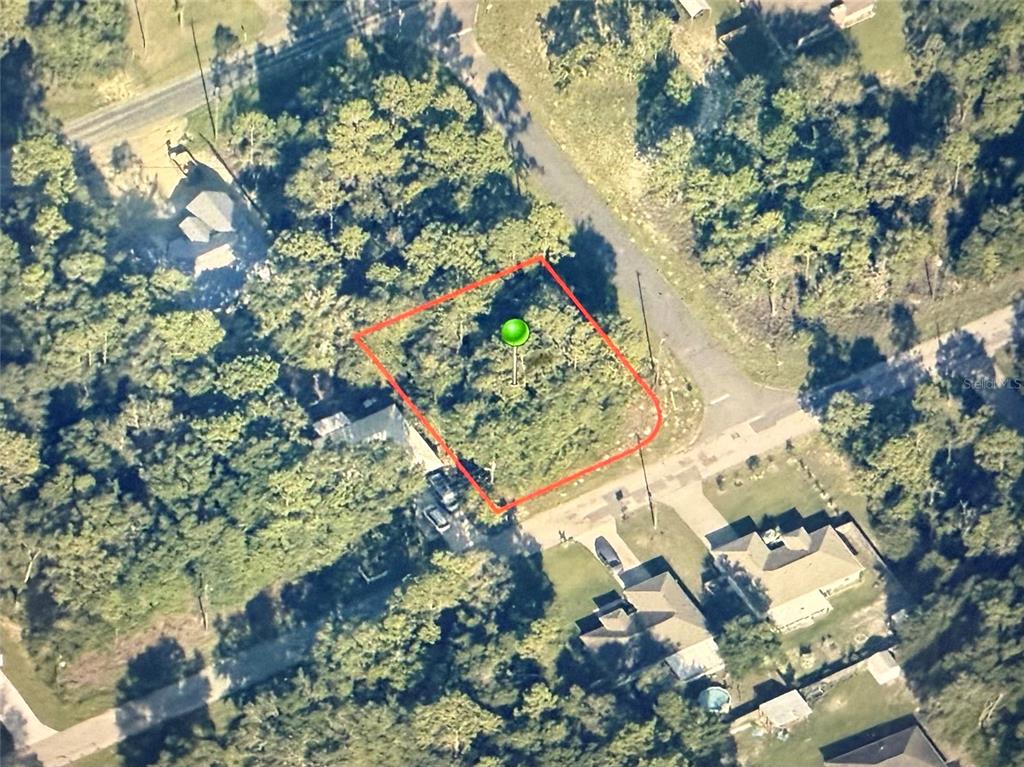 An aerial view shows a vacant, wooded residential lot outlined in red — 9540 N PINEVIEW WAY, CITRUS SPRINGS, FL