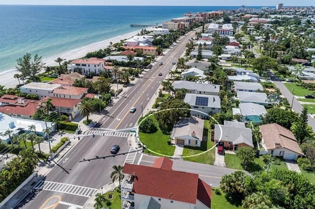 An aerial view shows a single-story house circled in a residential neighborhood near the beach — 16101 GULF BOULEVARD, REDINGTON BEACH, FL