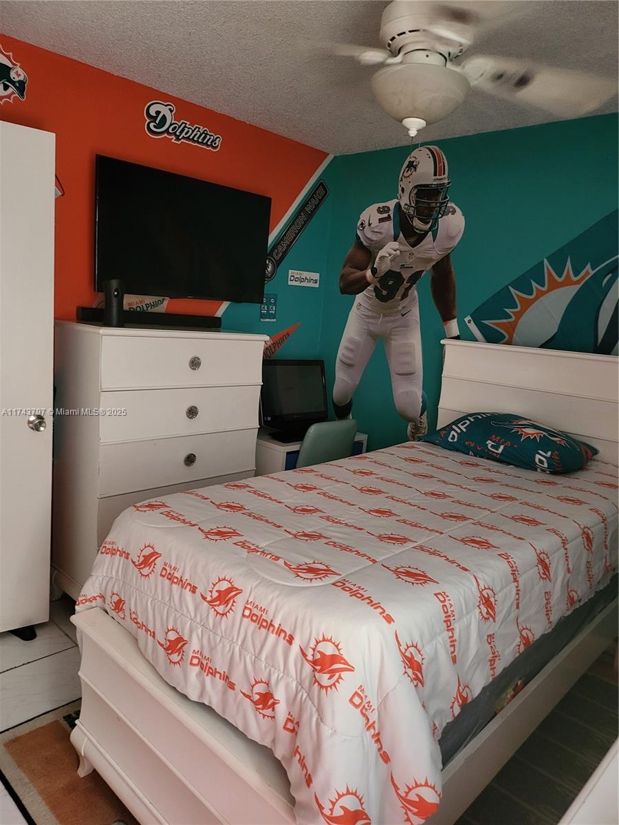 A bedroom decorated with Miami Dolphins themed bedding, wall decals, and team colors — 6771 NW 199th Ter, Hialeah FL 33015, HIALEAH, FL