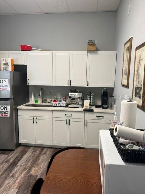 A kitchen area features white cabinets, a stainless steel refrigerator, and a coffee station — 1061 S SUN DRIVE UNIT 1065, LAKE MARY, FL