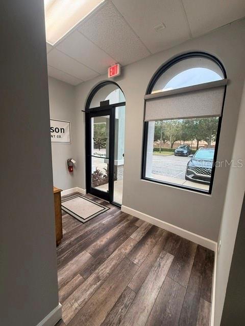 An entryway features wood-look flooring, a glass door, and an arched window overlooking a parking lot — 1061 S SUN DRIVE UNIT 1065, LAKE MARY, FL