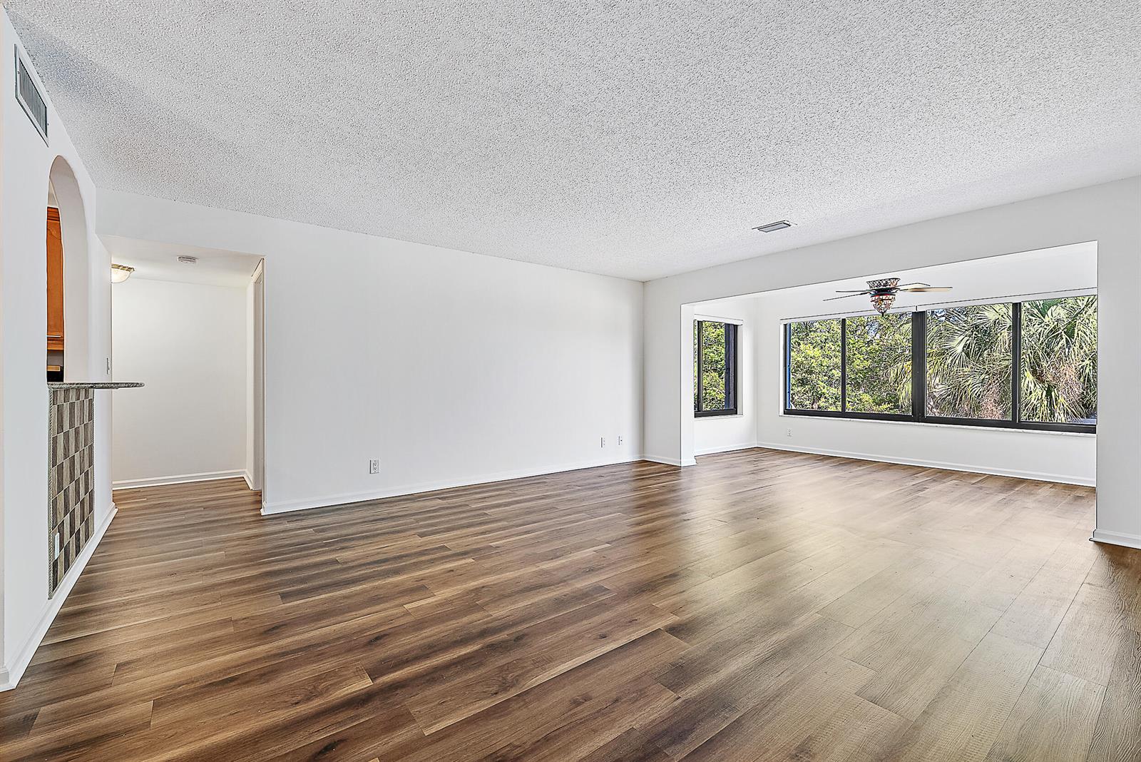 An aerial view shows multiple apartment buildings surrounded by green lawns and trees near the ocean — 300 N Highway A1a # 303g, Jupiter FL 33477, JUPITER, FL