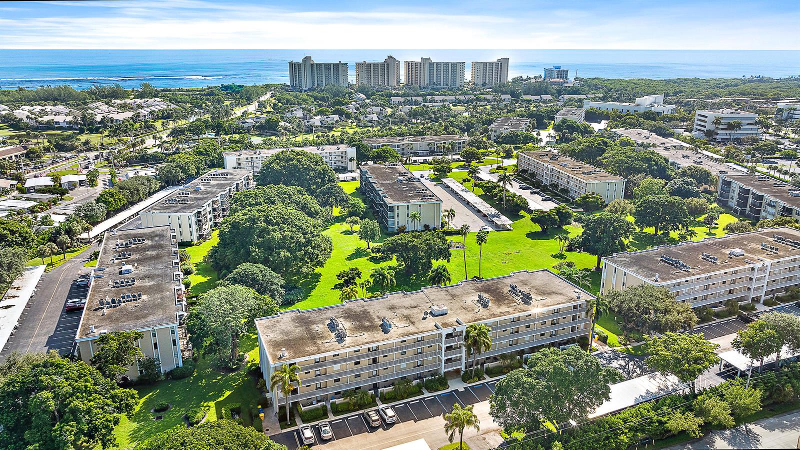 A kitchen features wood cabinets, granite countertops, stainless steel appliances, and an arched pass-through window — 300 N Highway A1a # 303g, Jupiter FL 33477, JUPITER, FL