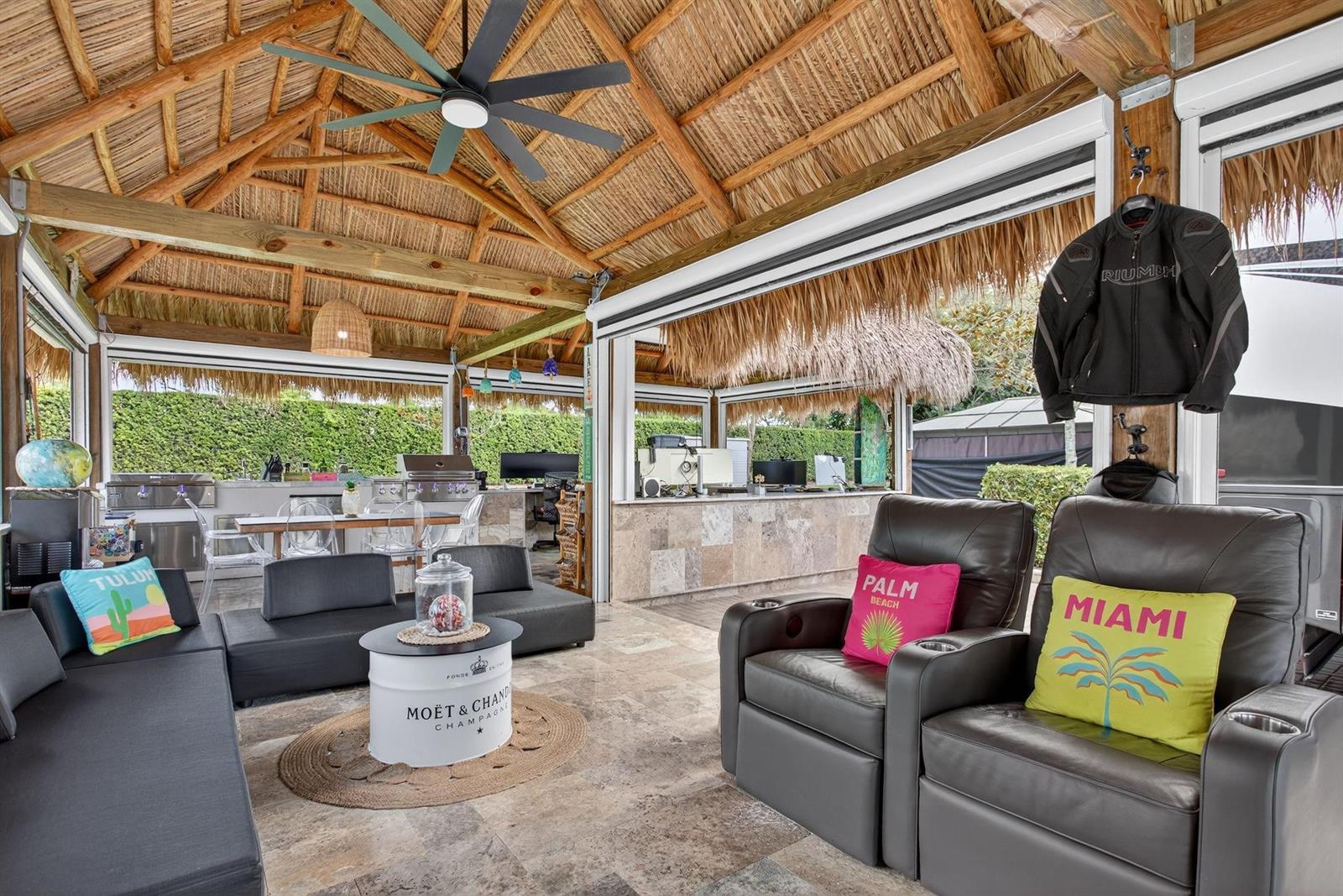 An open-air patio with a thatched roof, outdoor kitchen, lounge seating, and stone flooring — 161 N Cortez Drive # 161, Margate FL 33068, MARGATE, FL