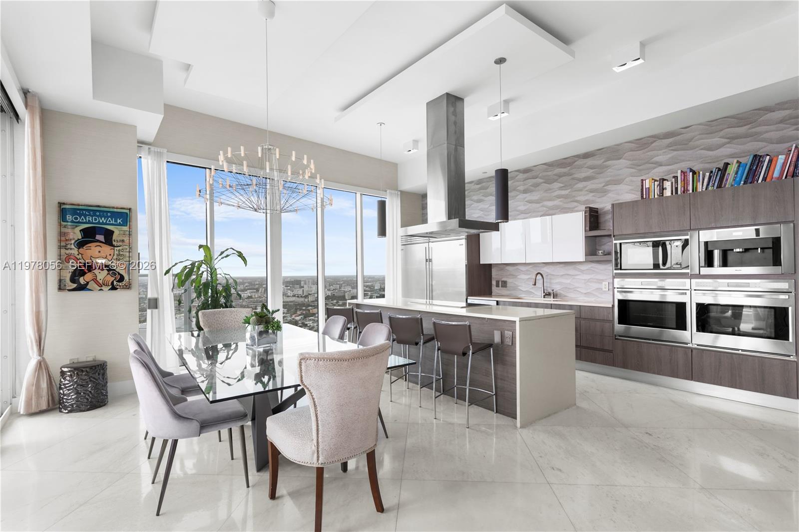 A modern kitchen and dining area features floor-to-ceiling windows, a glass table, and stainless appliances — 2020 N Bayshore Dr # 4702, Miami FL 33137, MIAMI, FL
