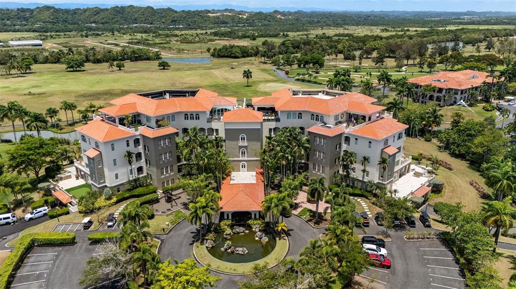 An aerial view shows a large, multi-story hotel building with a red-tiled roof and courtyard — 500 PLANTATION VILLAGE DRIVE UNIT 1201, DORADO, PR