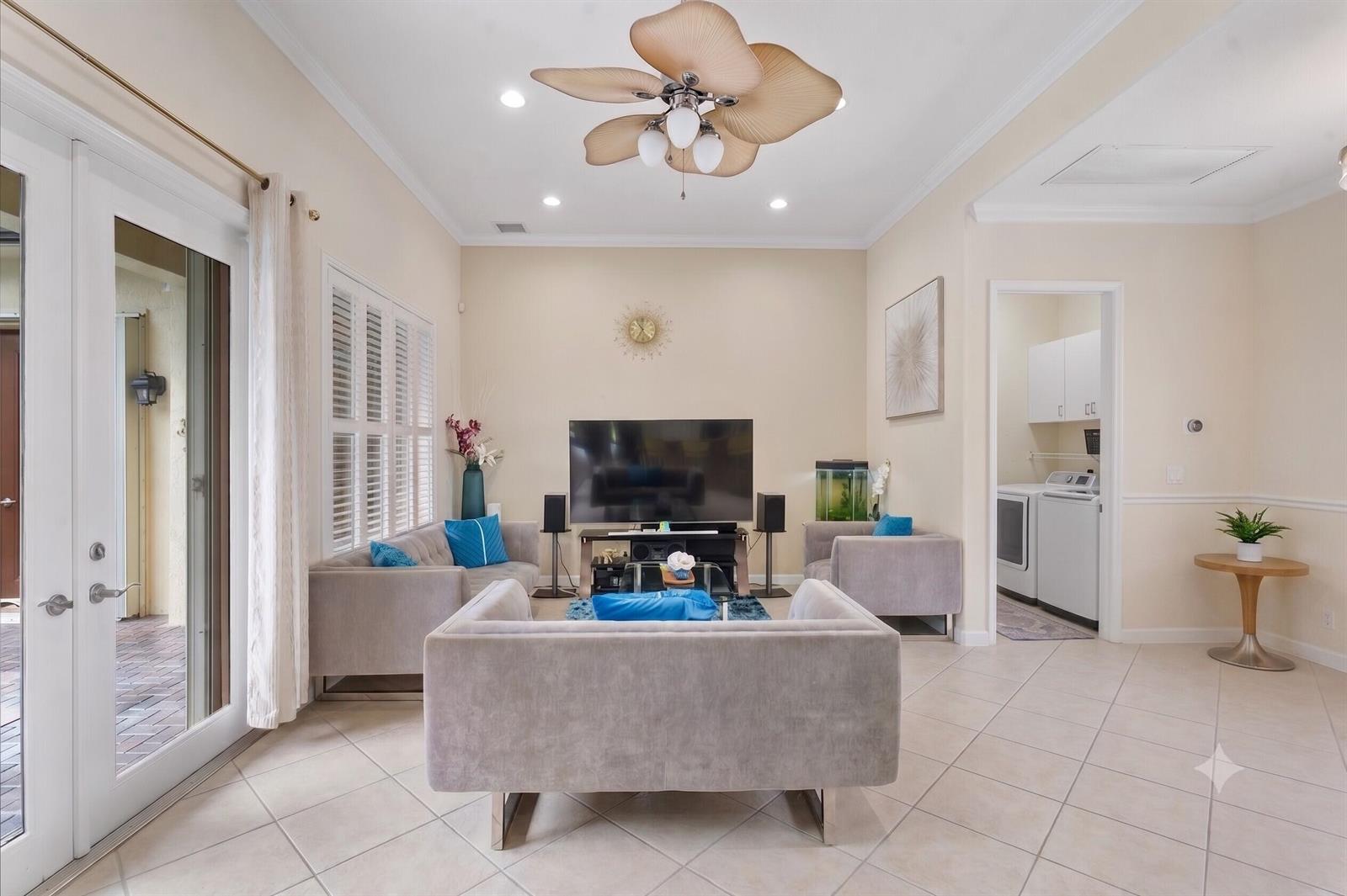 A single-story house with a brown garage door, tiled roof, and landscaped front yard — 11645 NW 71st Place, Parkland FL 33076, PARKLAND, FL
