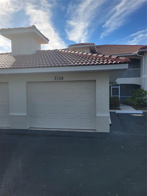 A beige garage with a tiled roof and the number 3104 above the door — 3104 L PAVIA BOULEVARD UNIT 3104, VENICE, FL
