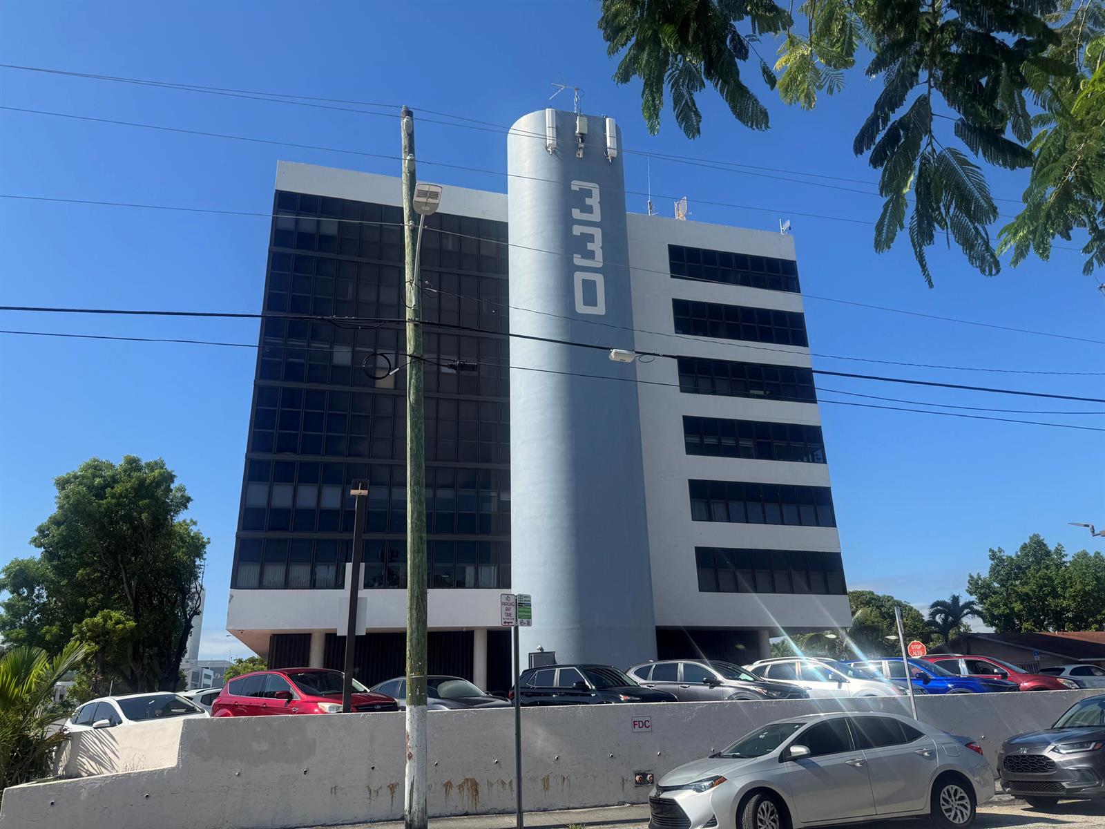 A multi-story office building features a prominent cylindrical tower with the number 330 displayed vertically — 330 SW 27th Avenue # 309, Miami FL 33135, MIAMI, FL