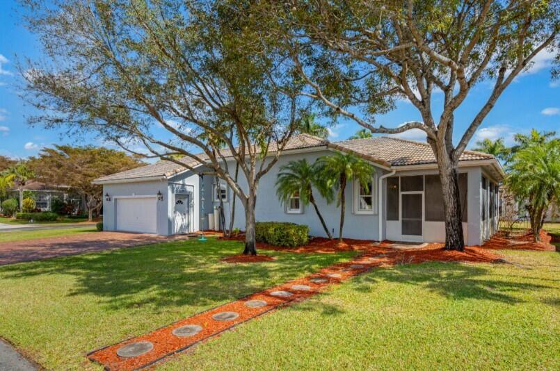 A light blue single-story house with a two-car garage, tile roof, and a screened porch — 2570 SE 4th Place, Homestead FL 33033, HOMESTEAD, FL