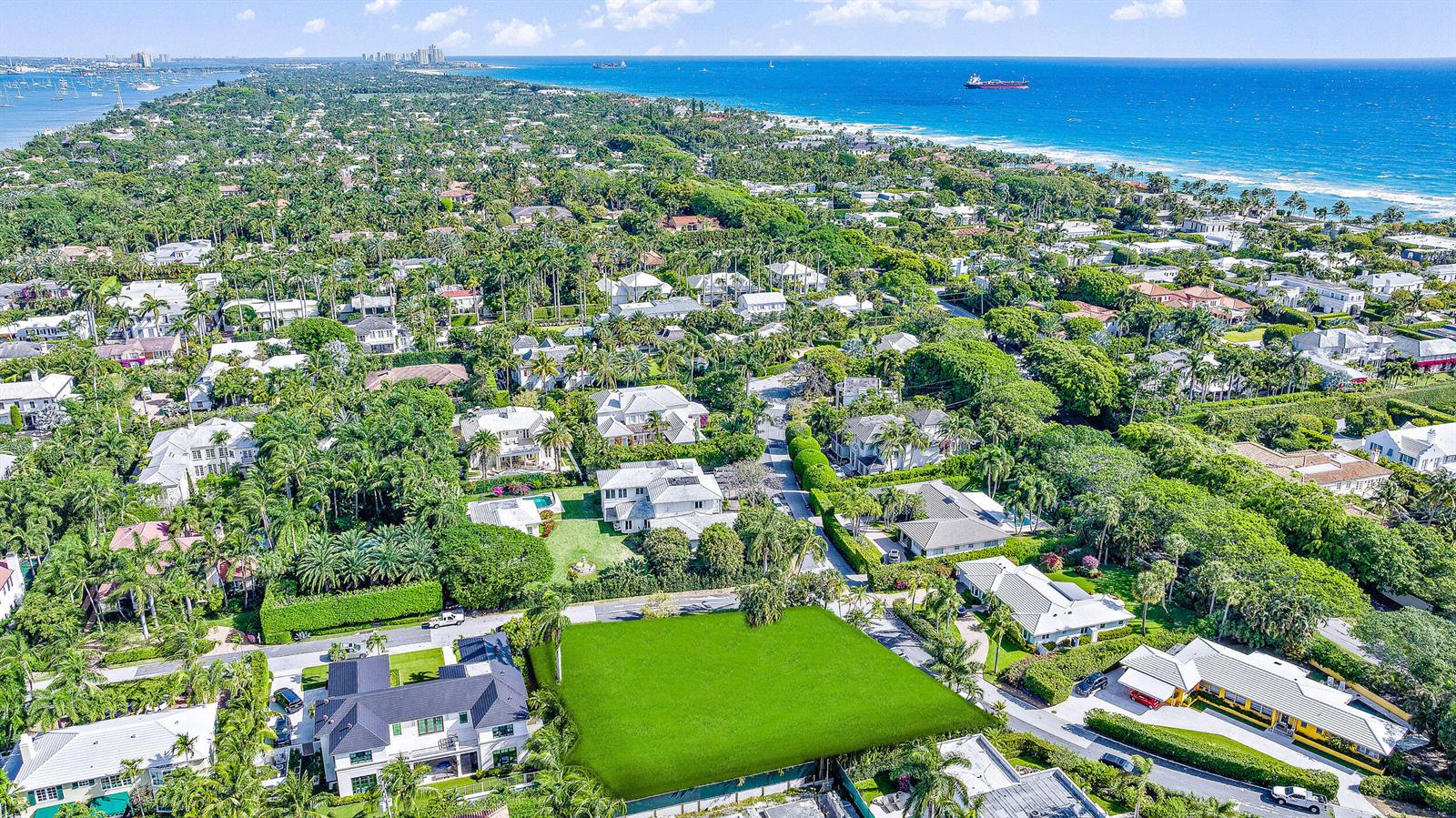 An aerial view shows a vacant, rectangular grassy lot surrounded by luxury homes and trees — 202 Coral Lane, Palm Beach FL 33480, PALM BEACH, FL