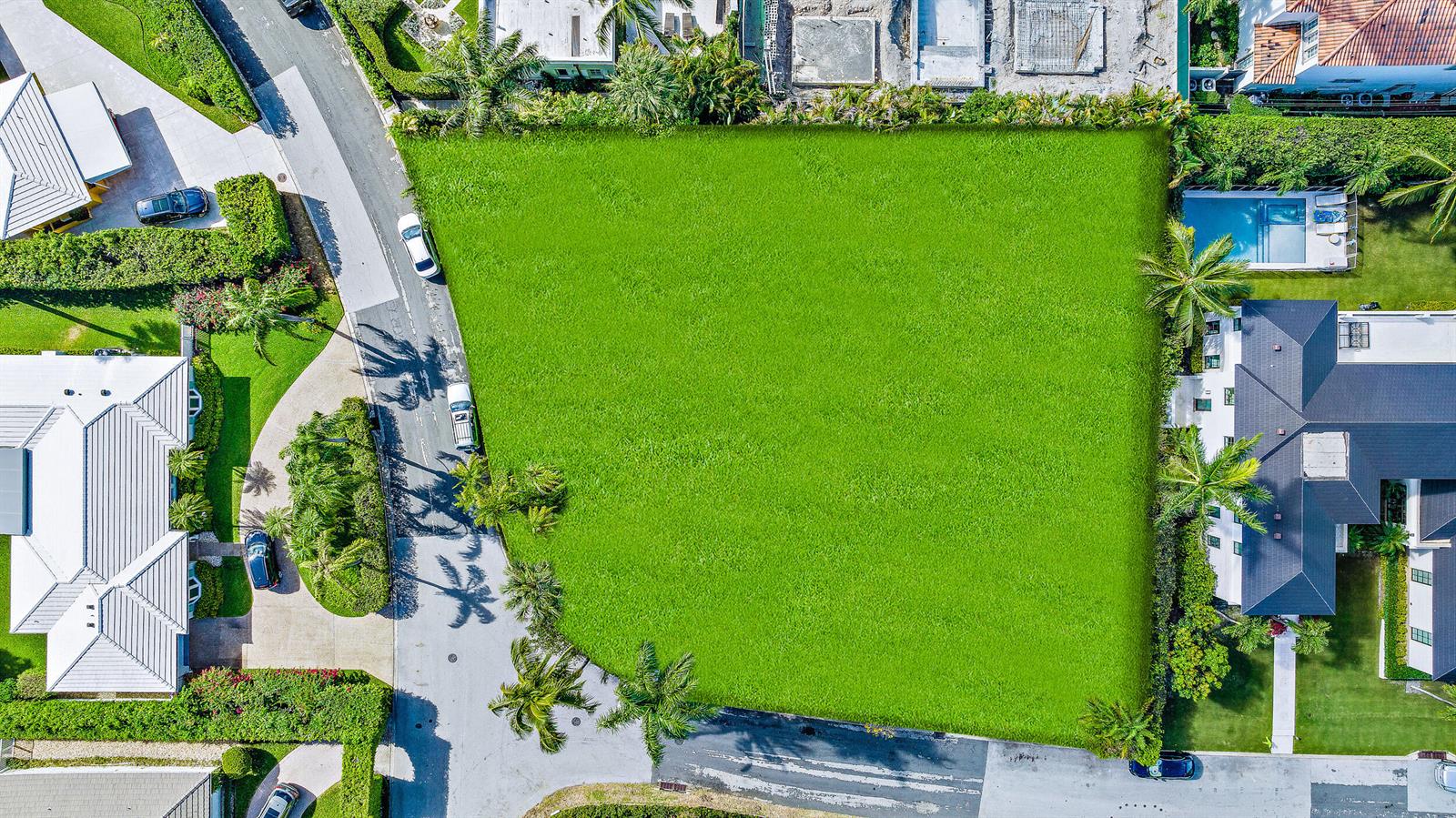 An aerial view shows a large, vacant rectangular grass lot situated between two residential properties — 202 Coral Lane, Palm Beach FL 33480, PALM BEACH, FL