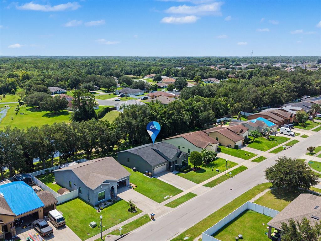 An aerial view of a suburban neighborhood featuring single-family homes with driveways and green lawns — 4824 ASHURST STREET, KISSIMMEE, FL