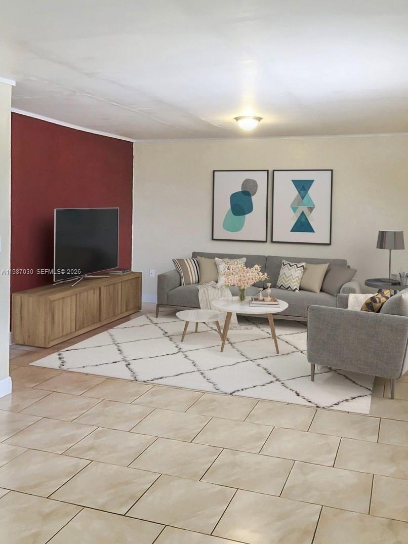 A living room features a red accent wall, a gray sofa, and a patterned rug — 4250 SW 67th Ave # 32, Miami FL 33155, MIAMI, FL