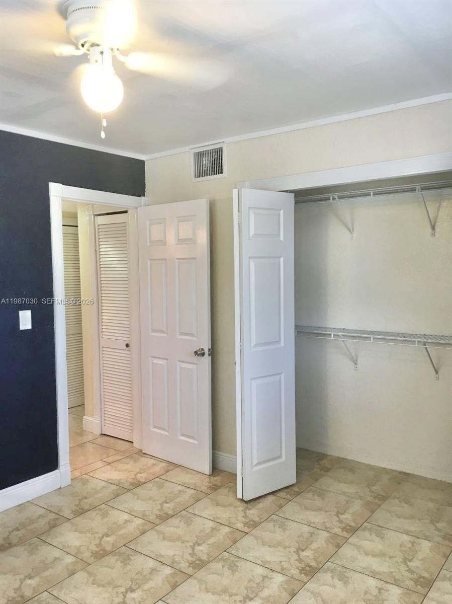 A room with tiled floors, a ceiling fan, a closet, and a doorway — 4250 SW 67th Ave # 32, Miami FL 33155, MIAMI, FL