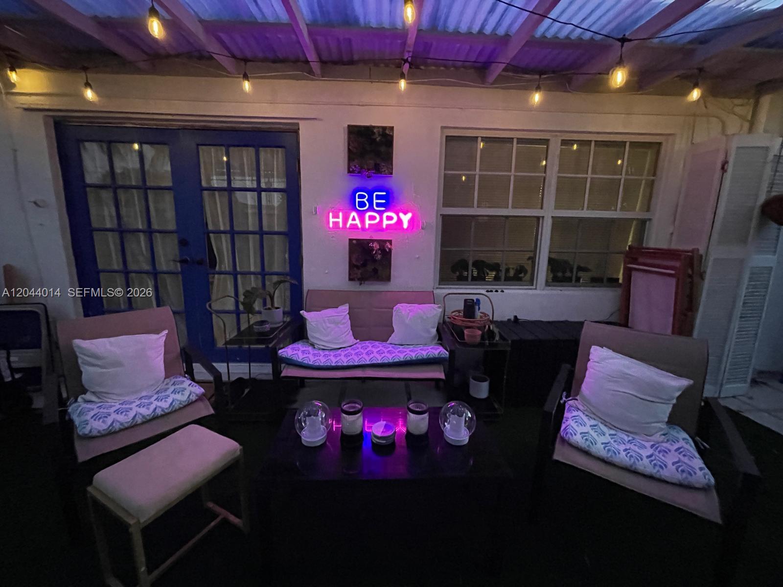 A covered patio features outdoor seating, a neon sign, and string lights — 6461 Miramar Pkwy, Miramar FL 33023, MIRAMAR, FL