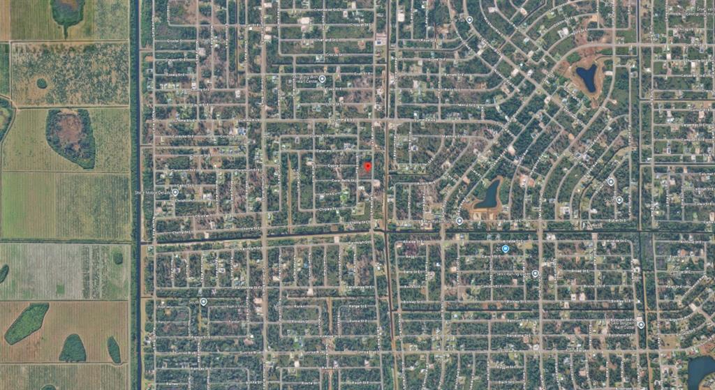 This is an aerial map view of a residential neighborhood with a red location marker — 329 GENOA AVENUE S, LEHIGH ACRES, FL