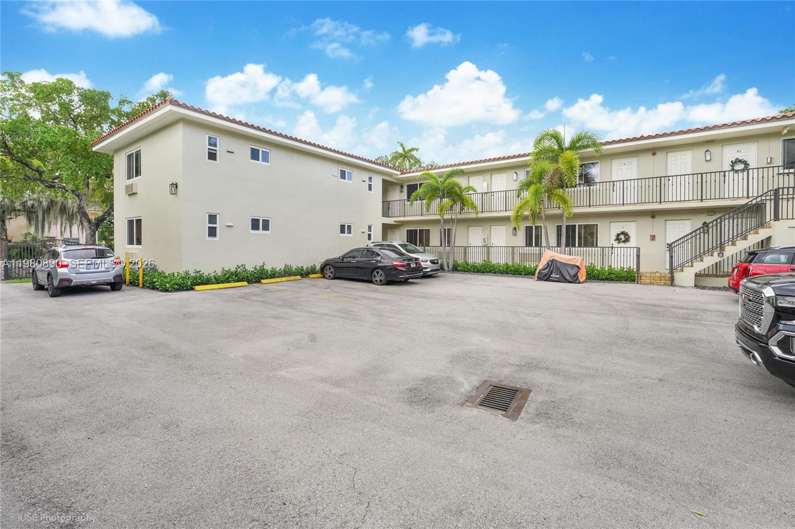 A two-story apartment building with a parking lot and palm trees in front — 35 Antilla Ave, Coral Gables FL 33134, CORAL GABLES, FL