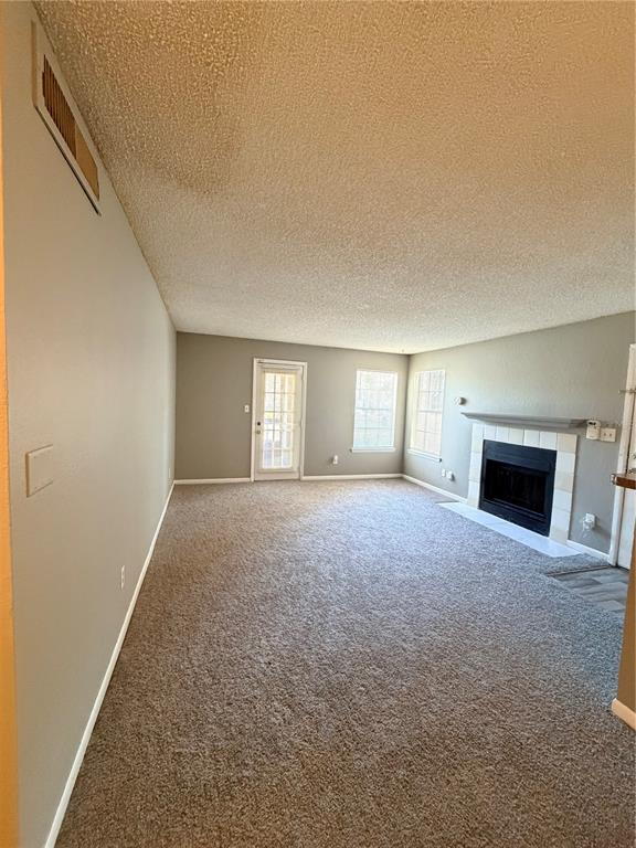 A living room features beige carpet, a fireplace with a tiled surround, and a glass door — 4367 THORNBRIAR LANE UNIT 107, ORLANDO, FL
