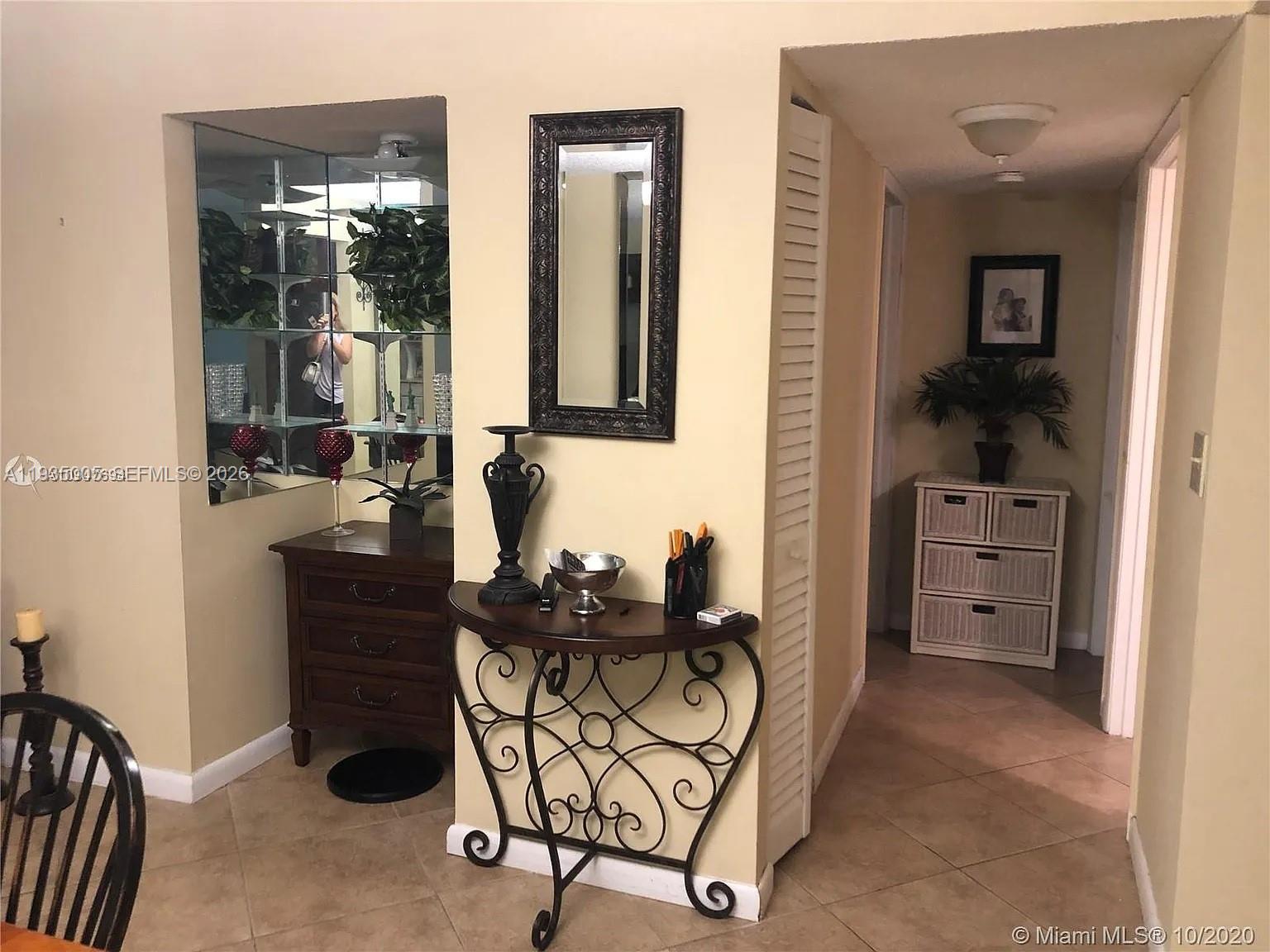 A spacious lobby features a coffered ceiling, tile floors, and multiple seating areas — 9440 SW 8th St # 402, Boca Raton FL 33428, BOCA RATON, FL