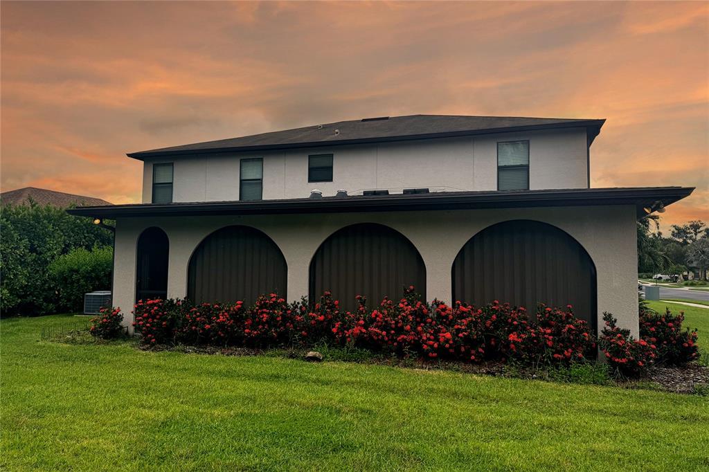 A sunroom features a sectional sofa, a pool table, and large arched windows overlooking greenery — 6103 HORSE MILL PLACE, PALMETTO, FL